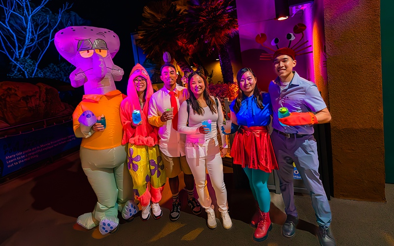 A group of people dressed up as characters from SpongeBob SquarePants stand together, wearing vibrant costumes.