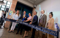 Dignitaries cut a ribbon to mark the opening of Beyster Little Blue Penguins.
