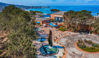 arial view of Birch Aquarium with whale statue in front and blue ocean stretching behind