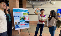 UC San Diego undergraduate students present their work to SCMA Co-director Isabel Rivera-Collazo. Photo by Nan Renner, Birch Aquarium.
