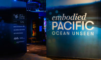 Entrance to Embodied Pacific: Ocean Unseen with the credit wall on the left and the title on the right