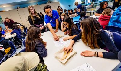 Students at table learn how to dissect a squid.