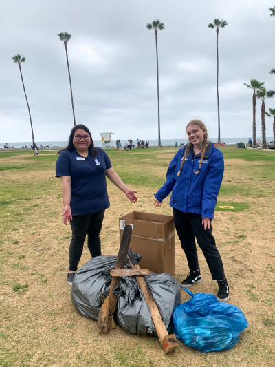 Two aquarium staff members Paola (left) and Jazz (right) show-off the trash and recycling collected by our awesome members.