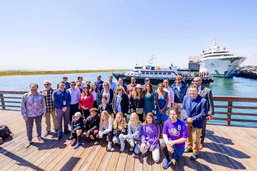 Group posing for photos on a dock at Seaport Village.